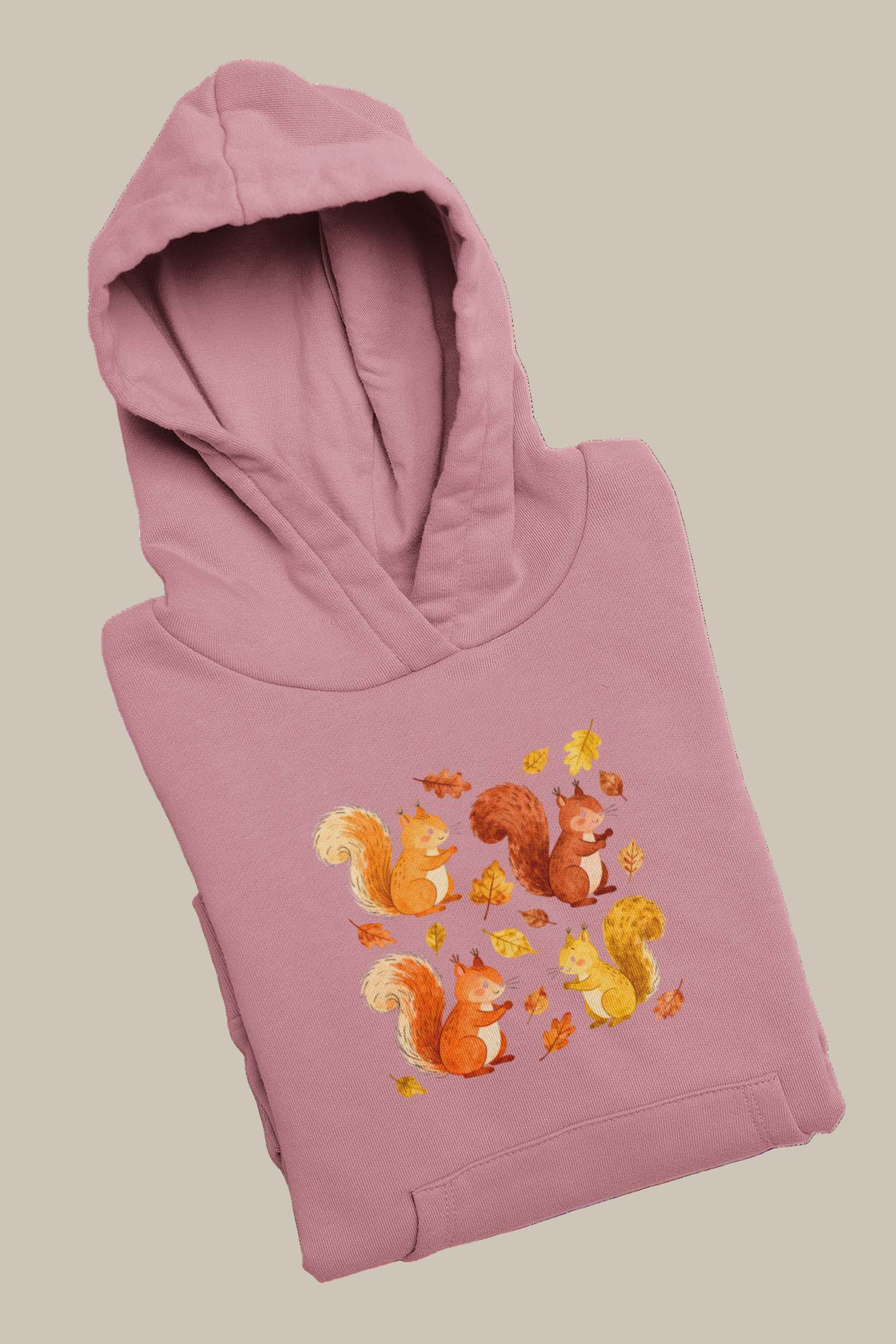 Folded pink hoodie with autumn-themed design
